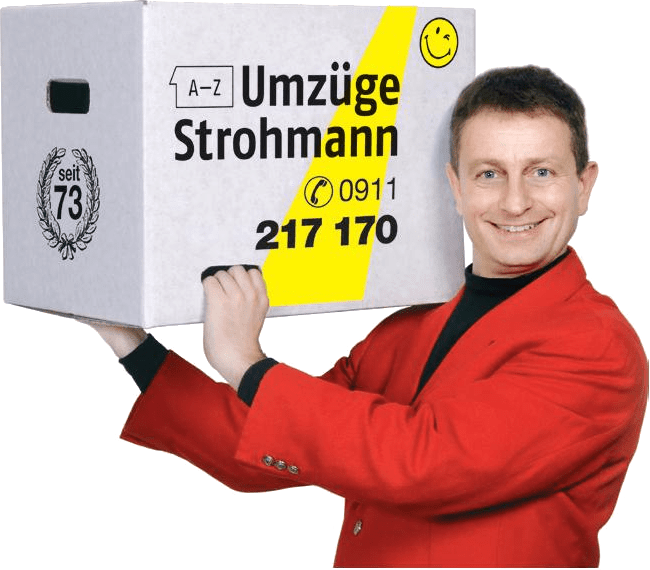 Thomas Kneißl im roten Sakko, einen Strohmann-Umzugskarton auf der Schulter